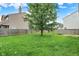 A large fenced-in backyard with grass and mature trees at 8212 Twin River Dr, Indianapolis, IN 46239