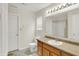 Well-lit bathroom with wood cabinets, a large mirror, and neutral colors at 8212 Twin River Dr, Indianapolis, IN 46239