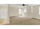 Spacious bedroom with ceiling fan, bright windows, and an en-suite bathroom at 8212 Twin River Dr, Indianapolis, IN 46239