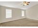 Spacious bedroom boasting bright windows, ceiling fan, and neutral paint at 8212 Twin River Dr, Indianapolis, IN 46239