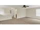 Upstairs bonus room features ceiling fan, neutral paint, and natural light at 8212 Twin River Dr, Indianapolis, IN 46239
