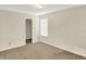 Neutral carpeted bedroom featuring natural light and a closet at 8212 Twin River Dr, Indianapolis, IN 46239