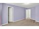 Carpeted bedroom featuring purple walls and white trim at 8212 Twin River Dr, Indianapolis, IN 46239