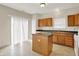 Well-lit kitchen with wooden cabinetry, a functional island, and sliding glass doors, offering convenience and style at 8212 Twin River Dr, Indianapolis, IN 46239