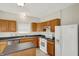 Bright kitchen featuring oak cabinets, white appliances, stainless dishwasher and a center island at 8212 Twin River Dr, Indianapolis, IN 46239