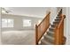 Inviting living room featuring large windows, neutral tones, and staircase at 8212 Twin River Dr, Indianapolis, IN 46239