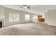 Spacious living room features plush carpeting, a cozy fireplace, and bright windows, creating a welcoming atmosphere at 8212 Twin River Dr, Indianapolis, IN 46239