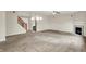 Expansive living area showcasing neutral carpet, staircase, fireplace, and chandelier lighting at 8212 Twin River Dr, Indianapolis, IN 46239