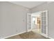 Office space featuring neutral walls, neutral carpet, and white french doors to the open-concept living area at 8212 Twin River Dr, Indianapolis, IN 46239
