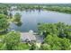 Breathtaking aerial view of a lake house, showcasing its lush surroundings and private dock at 9172 W Tulip Dr, Columbus, IN 47201