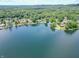 Stunning aerial view of lakefront homes nestled among lush greenery, offering a picturesque waterfront community at 9172 W Tulip Dr, Columbus, IN 47201