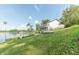 Picturesque backyard leading to a lake, complemented by a house with a balcony at 9172 W Tulip Dr, Columbus, IN 47201