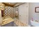 Charming bathroom with patterned wallpaper, granite countertop, and a toilet at 9172 W Tulip Dr, Columbus, IN 47201
