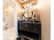 Elegant bathroom featuring modern fixtures, a sleek mirror, stylish lighting and an adjacent powder room at 9172 W Tulip Dr, Columbus, IN 47201