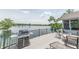 Spacious deck with grill and seating overlooking a serene lake, perfect for outdoor entertaining and relaxation at 9172 W Tulip Dr, Columbus, IN 47201