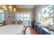 Bright dining area features an elegant light fixture and sliding doors with scenic lake views at 9172 W Tulip Dr, Columbus, IN 47201