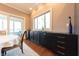 Elegant dining area features dark cabinetry, hardwood floors, and a sliding door with scenic views of outdoor area at 9172 W Tulip Dr, Columbus, IN 47201
