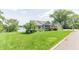 Charming home with a well-manicured lawn, lake view, and inviting curb appeal at 9172 W Tulip Dr, Columbus, IN 47201