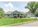 Charming single-story home with a stone facade, manicured lawn, and attached garage at 9172 W Tulip Dr, Columbus, IN 47201