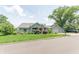Charming single-story home with a stone facade, manicured lawn, and attached garage at 9172 W Tulip Dr, Columbus, IN 47201