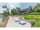 Multi-level deck and patio offer a spacious outdoor area with lake access and landscaped surroundings at 9172 W Tulip Dr, Columbus, IN 47201