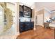 Chic wet bar featuring dark cabinets, granite countertops, and open access to a large pantry at 9172 W Tulip Dr, Columbus, IN 47201