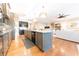 Well-lit kitchen featuring an island, stainless steel appliances and dark wood cabinets at 9172 W Tulip Dr, Columbus, IN 47201