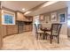 Charming kitchenette with wood cabinets, stainless steel dishwasher, and herringbone pattern tile floors at 9172 W Tulip Dr, Columbus, IN 47201