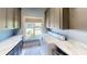 Laundry room showing the window, modern cabinetry with hardware, marble counters, and included washer/dryer at 9172 W Tulip Dr, Columbus, IN 47201