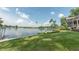 Beautiful lake views from the grassy lawn and landscaped backyard at 9172 W Tulip Dr, Columbus, IN 47201