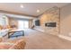 Open living room with a stone fireplace, comfortable seating, and sliding glass doors to the outdoors at 9172 W Tulip Dr, Columbus, IN 47201
