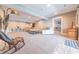 Bright living room with a cozy seating arrangement and stairs to the upper level of the home at 9172 W Tulip Dr, Columbus, IN 47201