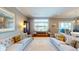 Elegant living room with comfortable sofas, a large window with a lake view, and refined decor at 9172 W Tulip Dr, Columbus, IN 47201
