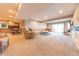 Open living room with comfortable seating, stone fireplace, and kitchenette in the background at 9172 W Tulip Dr, Columbus, IN 47201