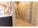 Walk-in shower featuring beige tilework with glass tile accents, a corner seat, and a modern shower head at 9172 W Tulip Dr, Columbus, IN 47201