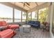 Inviting sunroom with comfortable seating and panoramic views of the lake, perfect for relaxation at 9172 W Tulip Dr, Columbus, IN 47201