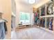 Spacious walk-in closet with custom shelving, storage, a window seat and plush carpet at 9172 W Tulip Dr, Columbus, IN 47201