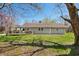Charming home with a brown roof, gray siding, and a covered deck, surrounded by a lush lawn and trees, creating a serene outdoor space at 9267 N State Road 135, Morgantown, IN 46160