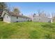 Wide view of home and detached garage with neatly mowed lawn and mature trees at 9267 N State Road 135, Morgantown, IN 46160