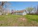 Home exterior in a natural setting, showcasing a lush backyard and mature trees at 9267 N State Road 135, Morgantown, IN 46160