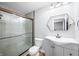 Bathroom featuring a glass shower door, single sink vanity, and decorative mirror at 9267 N State Road 135, Morgantown, IN 46160