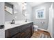 Bathroom with a double sink vanity with dark wood cabinets and quartz countertops, and two decorative mirrors at 9267 N State Road 135, Morgantown, IN 46160