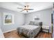 Bedroom featuring a bed, ceiling fan, and light gray walls over wood-look flooring at 9267 N State Road 135, Morgantown, IN 46160