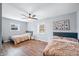 Bright bedroom featuring two beds, ceiling fan, and light gray walls over wood-look flooring at 9267 N State Road 135, Morgantown, IN 46160