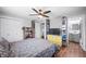 Bedroom featuring a bed, ceiling fan, closet and TV over wood-look flooring at 9267 N State Road 135, Morgantown, IN 46160