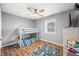 Bright bedroom featuring a bunk bed, ceiling fan, and light gray walls over wood-look flooring at 9267 N State Road 135, Morgantown, IN 46160
