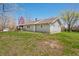 Charming home with a brown roof, gray siding, and a deck, surrounded by a lush lawn and trees, creating a serene outdoor space at 9267 N State Road 135, Morgantown, IN 46160