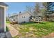Side view of the home with neutral siding, inviting covered deck, and a well maintained backyard at 9267 N State Road 135, Morgantown, IN 46160