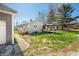 View of the home's exterior featuring neutral siding, a covered deck area, and a well-maintained lawn at 9267 N State Road 135, Morgantown, IN 46160