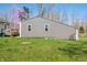 Detached garage with gray siding, well-kept lawn and beautiful landscaping at 9267 N State Road 135, Morgantown, IN 46160